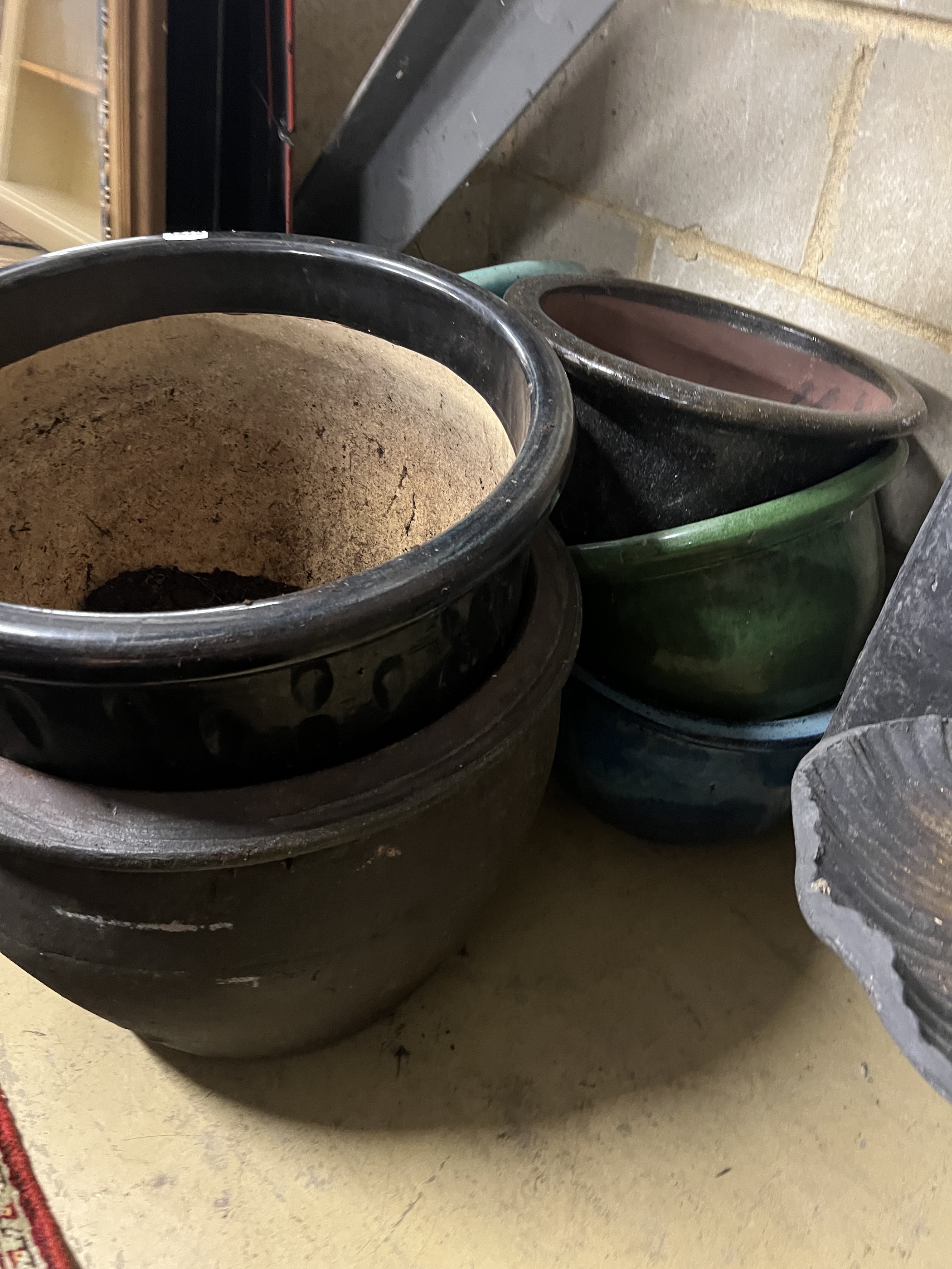 Seven assorted glazed earthenware garden planters, largest diameter 45cm, height 37cm